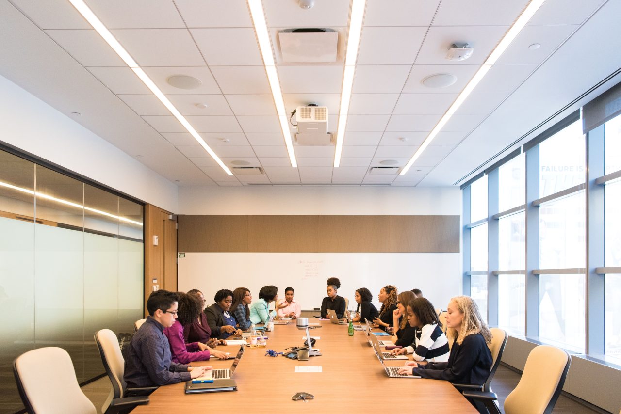 A multicultural team collaborating around a table in a conference room