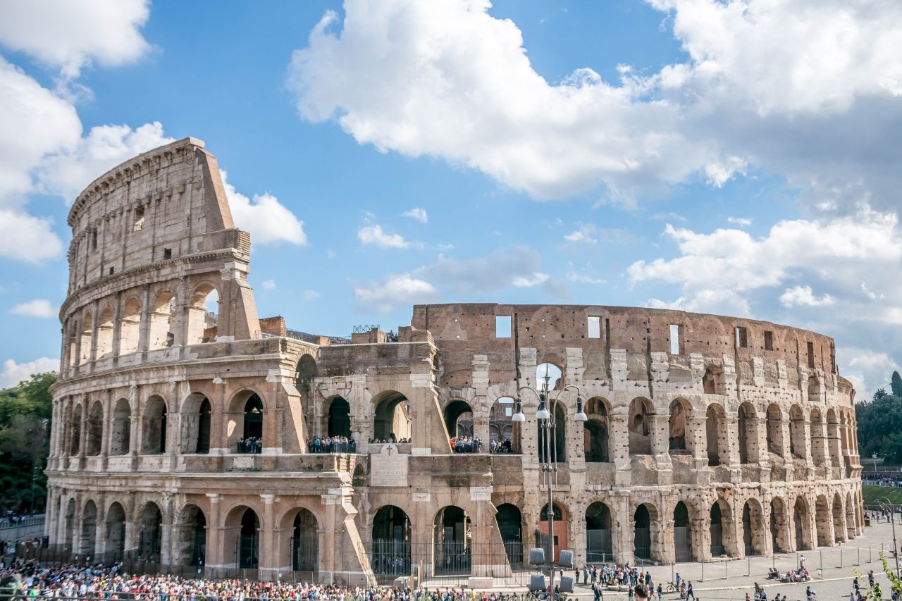 The Colosseum in Rome under a clear blue sky
